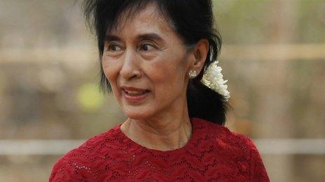 Aung San Suu Kyi carries flowers as she visits a polling station in Kawhmu township, Burma, 1 April 2012