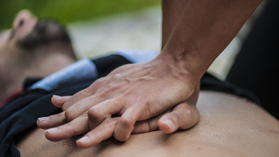 Man giving chest compressions or CPR