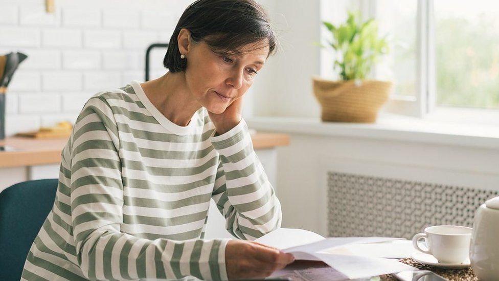 Woman concerned about bills sat at table