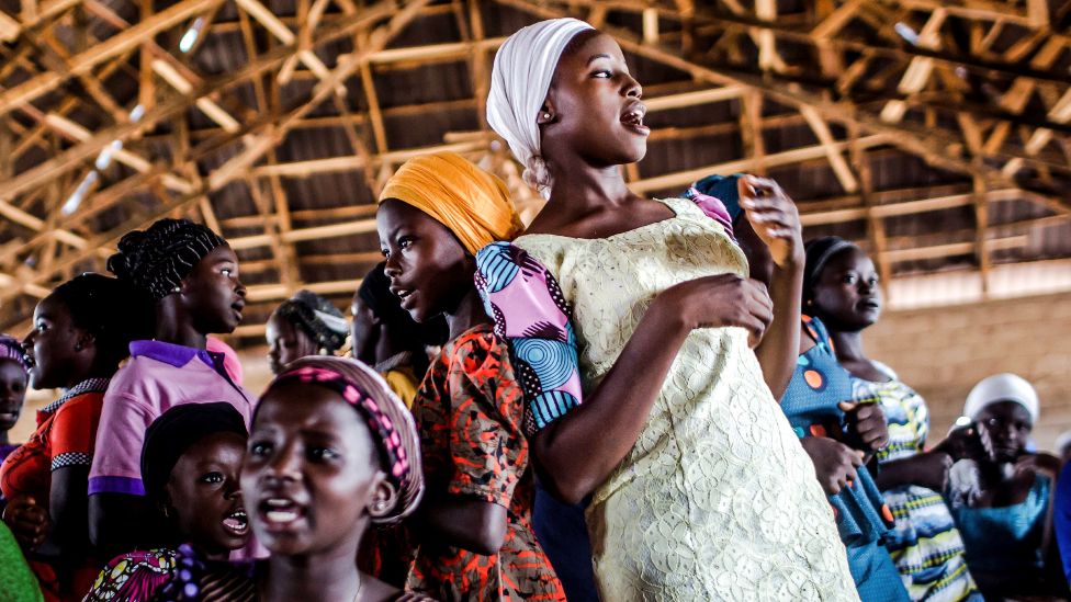 A group of Christian farmers sing and dance during the Sunday's service at Ecwa Church in Kaduna State - an area afflicted by religious strife