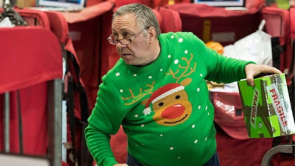 Royal Mail worker in a Christmas jumper