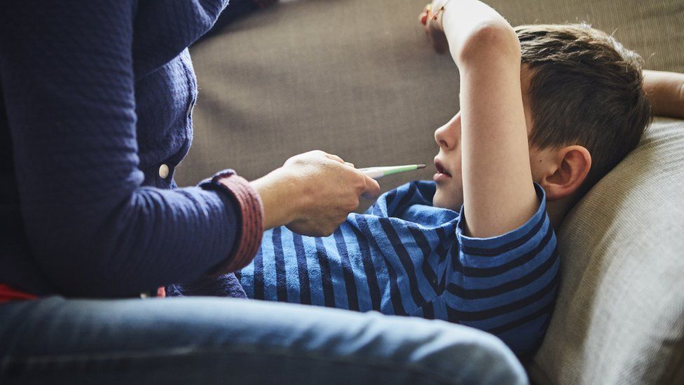 A child and a thermometer