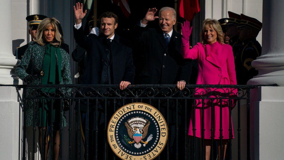 The Bidens and the Macrons wave from the White House