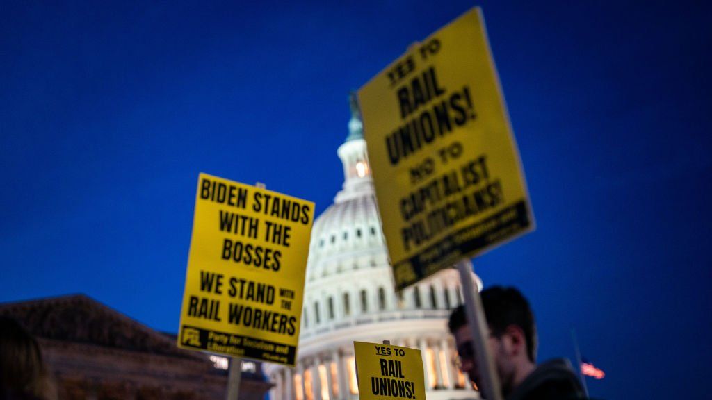 Signs outside the US Capitol that read 'Biden Stands with the Bosses, we Stand with the Rail Workers.'