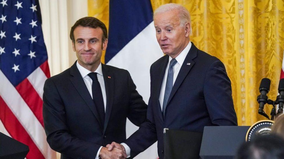 US President Joe Biden (R) and French President Emmanuel Macron (L) shake hands after speaking at a press conference in the East Room of the White House in Washington, DC, USA, 01 December 2022