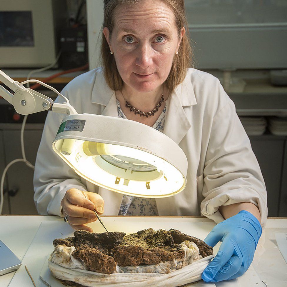 Conservator Liz Barham working on the burial