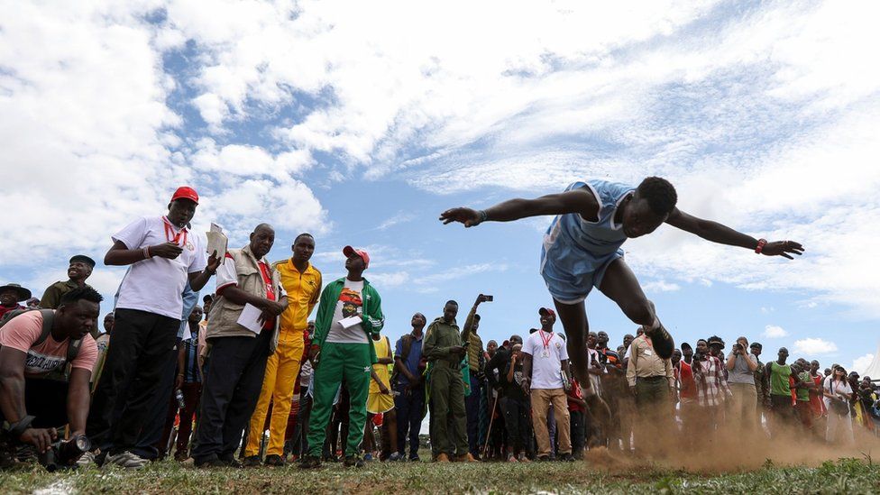 A Maasai Moran lifts off the ground while competing in the Javelin competition