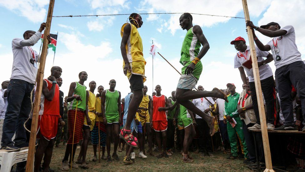 Maasai Warriors compete in a traditional high-jump competition