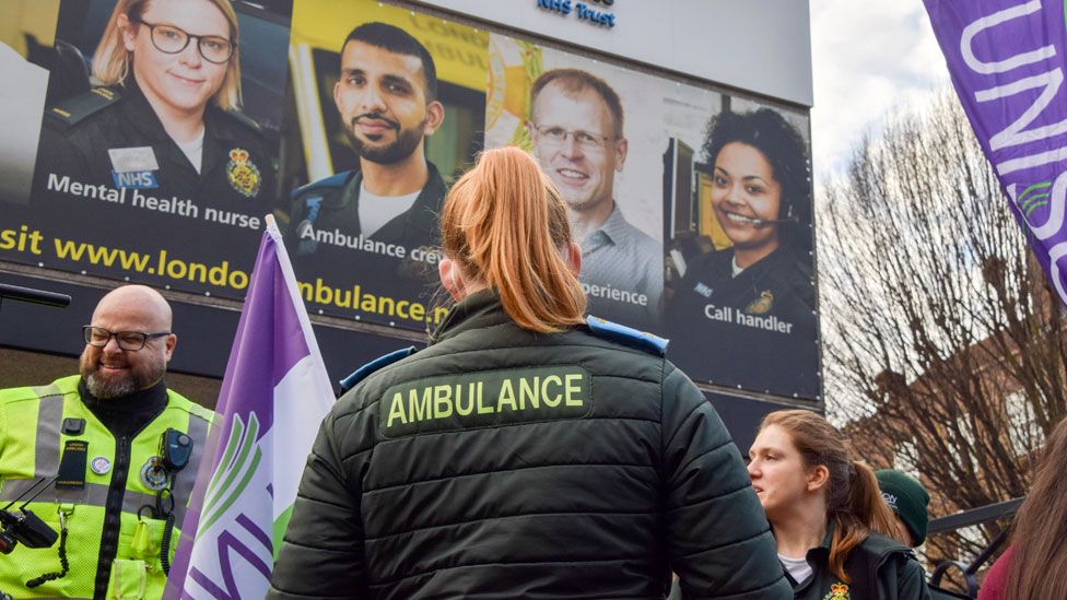 Ambulance workers stand at the Unison picket outside the London Ambulance Service headquarters on 21 December 2022