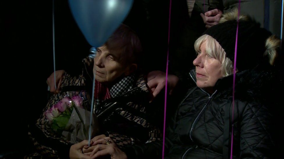 Women seated at the vigil