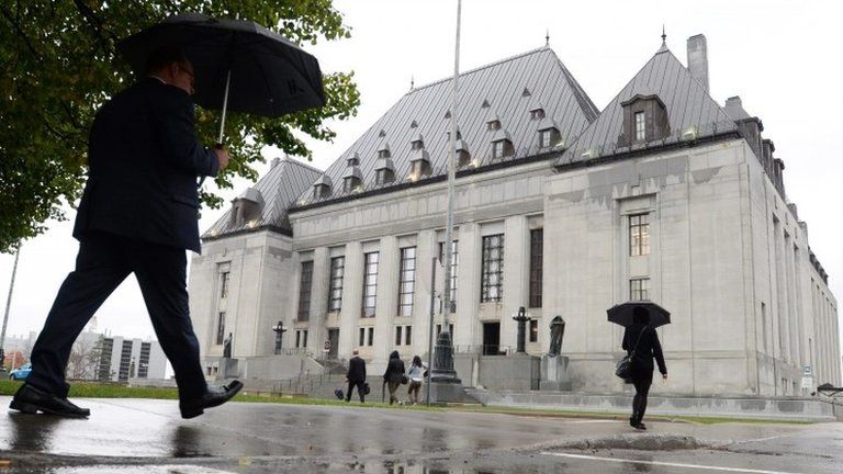 people walk outside the Supreme Court of Canada in Ottawa, Ontario 15 October 2015