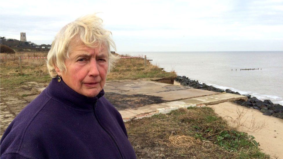 Bryony Nierop-Reading by the former garage floor which still overhangs the edge of the cliff