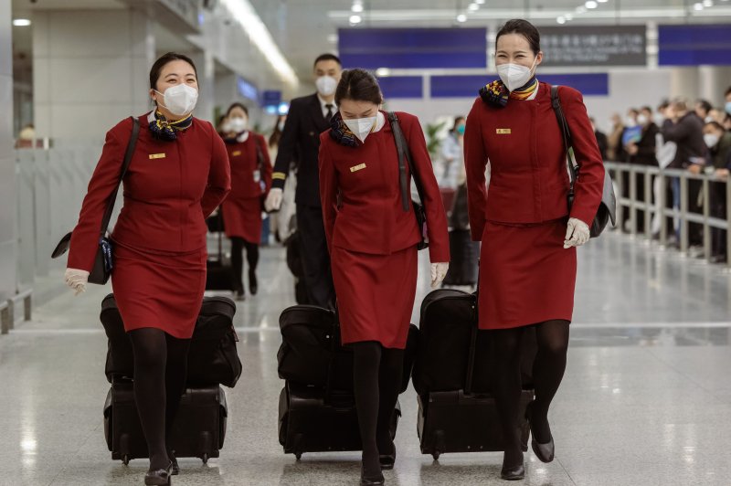 Cabin crew walk towards the exit of Pudong International Airport in Shanghai, on Sunday. China has reopened its borders and no longer requires quarantine for inbound travellers. Photo byAlex Plavevski/EPA-EFE