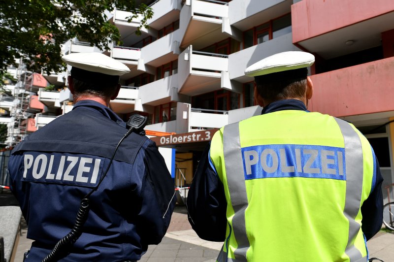 Police officers stand guard in front of an apartment block in the Chorweiler district of Cologne, Germany, in June 2018 after police found ricin meant for the production of a biological contaminating device. On Sunday, an 32-year-old Iranian man was arrested in Germany on suspicion of plotting a terror attack with ricin. File Photo by Sascha Steinbach/EPA-EFE