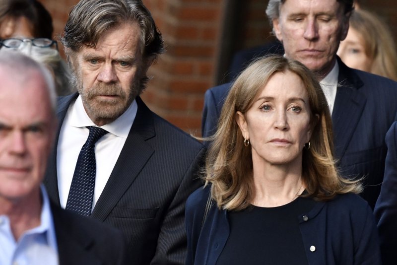 "Desperate Housewives" star Felicity Huffman leaves a Boston federal court with her husband, William H. Macy, in 2019 after being sentenced to 14 days for her role in the "Varsity Blues" scandal. File photo by Josh Reynolds/UPI | <a href="/News_Photos/lp/83cf6710d4a38b281f0e01c57383dd1d/" target="_blank">License Photo</a>