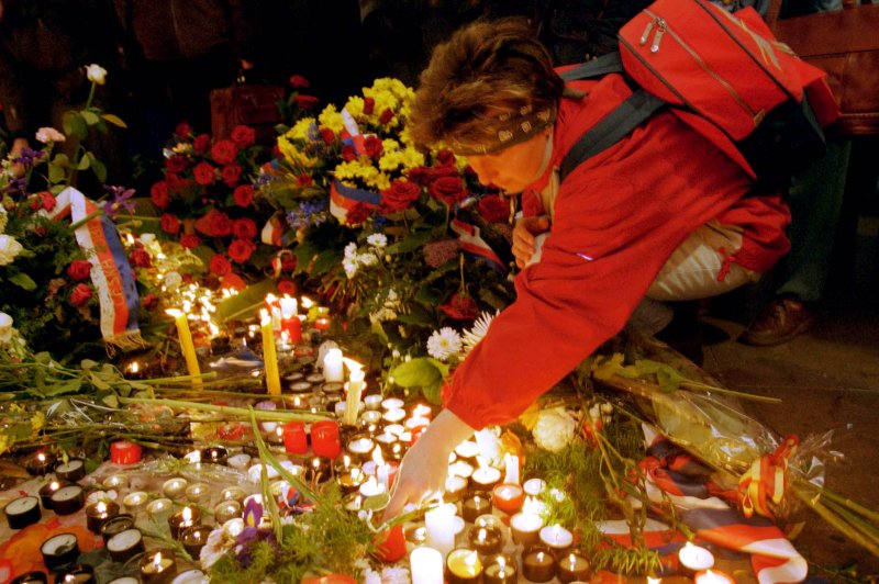 A woman lights a candle November 17, 1999, in Prague at the monument commemorating a violent attack by police in 1989 on students during the beginnings of Czechoslovakia's Velvet Revolution. The revolution led to the dissolution of Czechoslovakia into the Czech Republic and Slovakia, which happened on this day in 1993. File Photo by Sean Gallup/UPI | <a href="/News_Photos/lp/3ad52062f9d0a9931c052f2035d9500a/" target="_blank">License Photo</a>