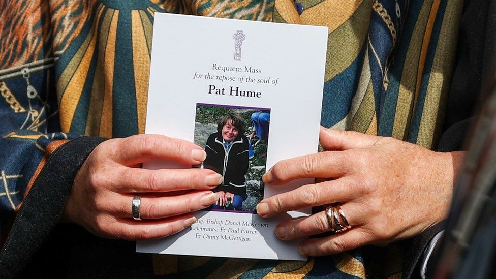 Woman holding Funeral booklet