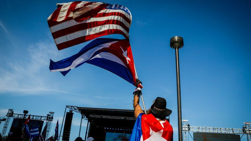 A US and Cuban flag