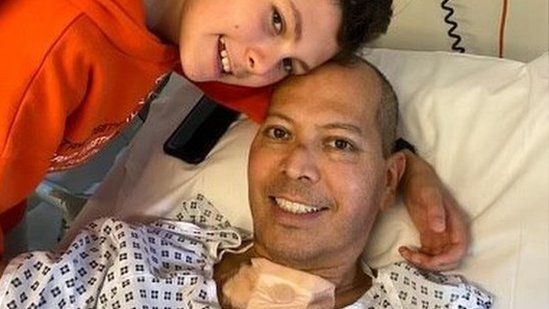 Mr Franco posing with his son Gabriel while he recovers in a hospital bed.