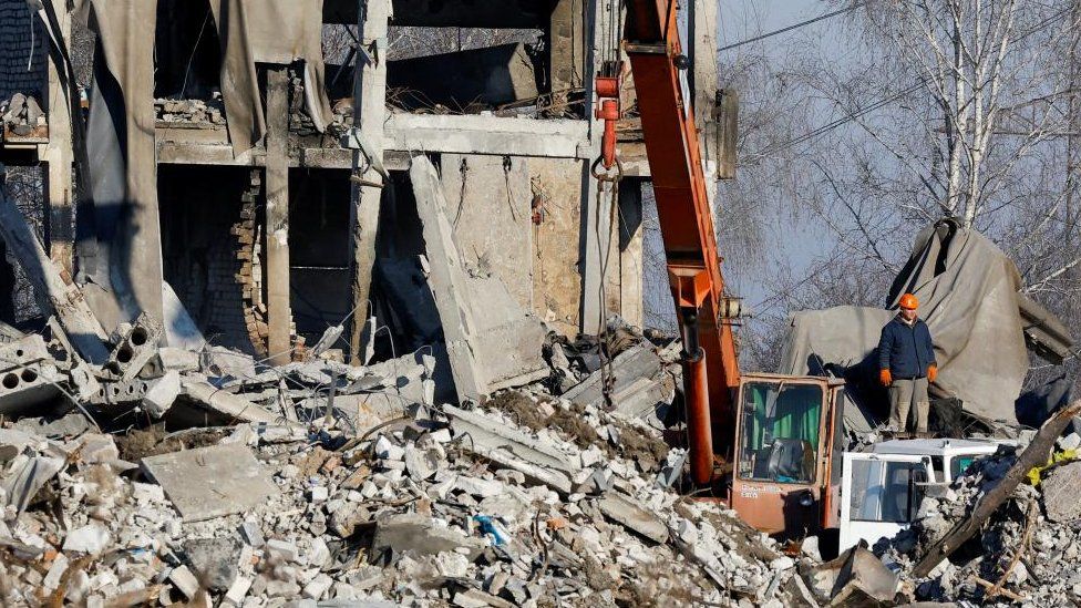 Workers remove debris of a destroyed building, purported to be a vocational college used as temporary accommodation for Russian soldiers, 63 of whom were killed in a Ukrainian missile strike, as stated the previous day by Russia's Defence Ministry, in the course of Russia-Ukraine conflict in Makiivka (Makeyevka), Russian-controlled Ukraine, January 3, 2023.