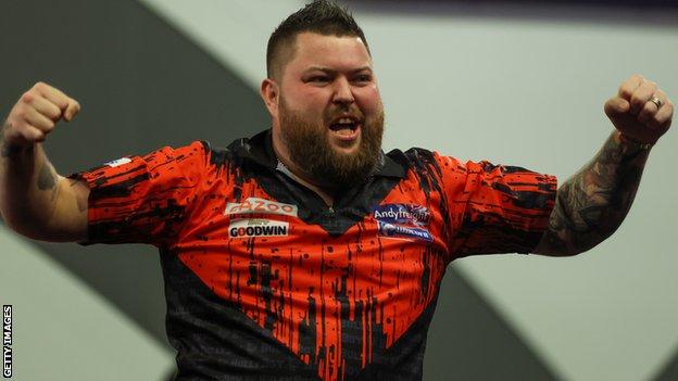 Michael Smith celebrates