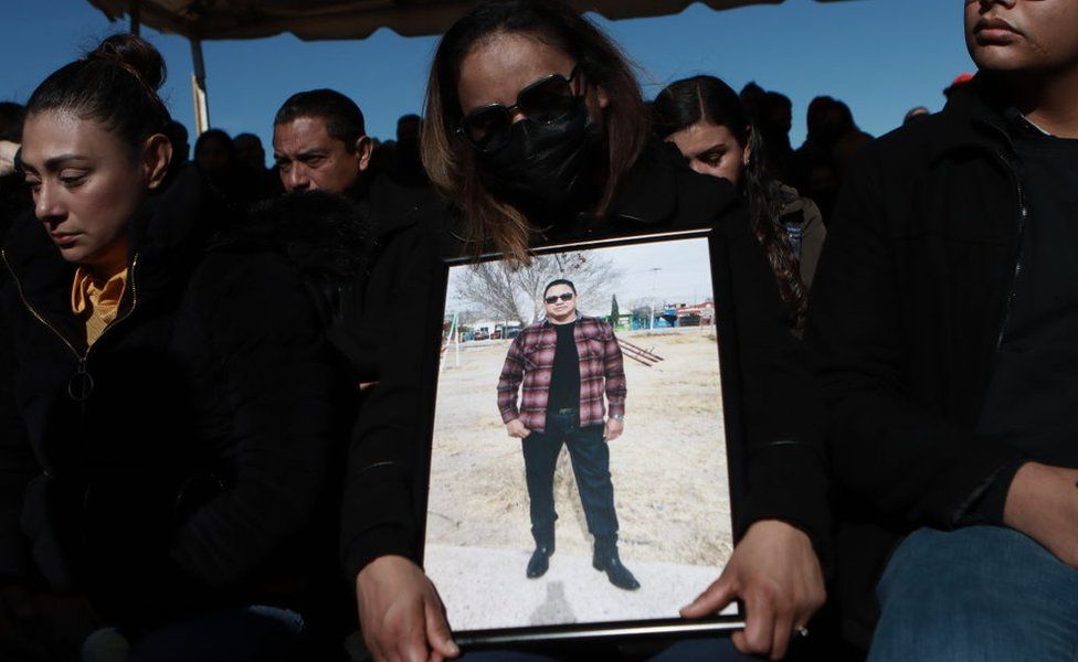 Relatives mourn during the funeral of guards killed in Sunday's prison break in Ciudad Juárez, Mexico