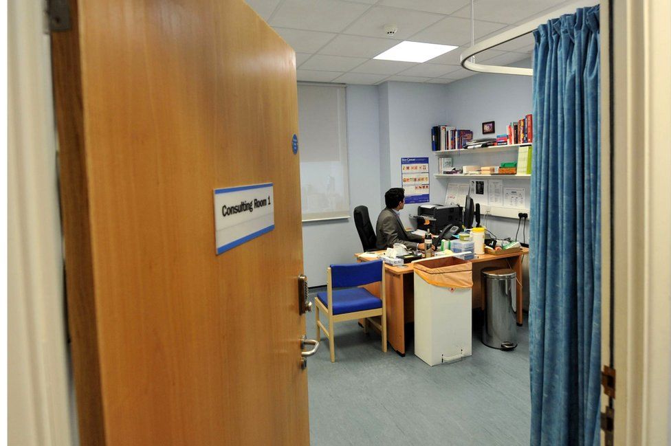 GP in a consulting room