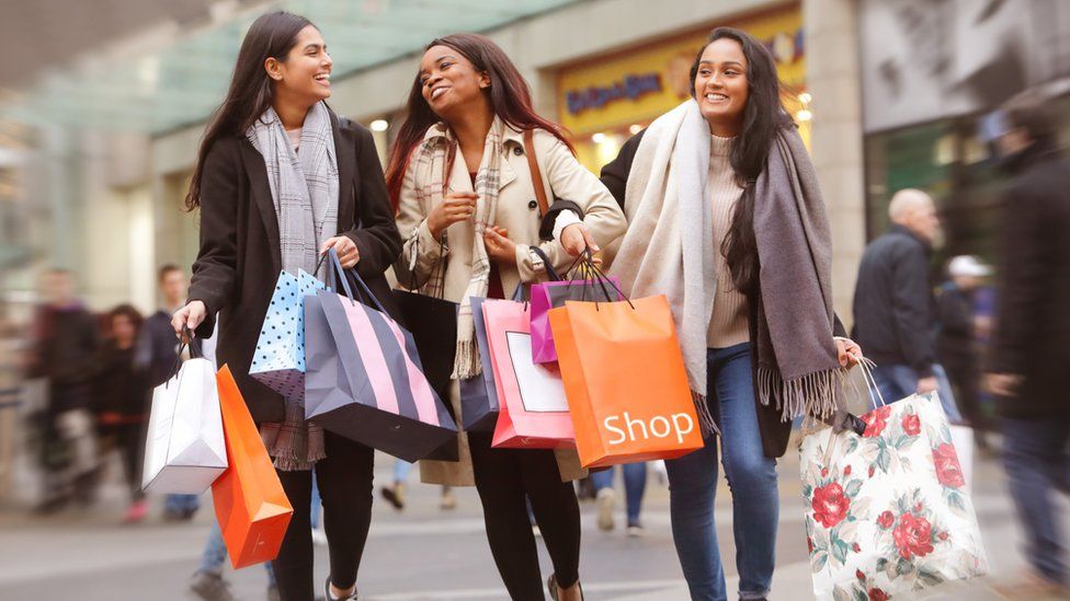 Three shoppers looking happy