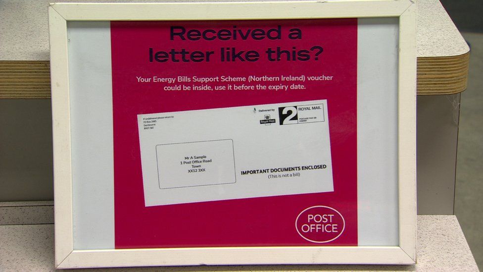 A bill board showing a mock up of the energy payment voucher letter that people will get