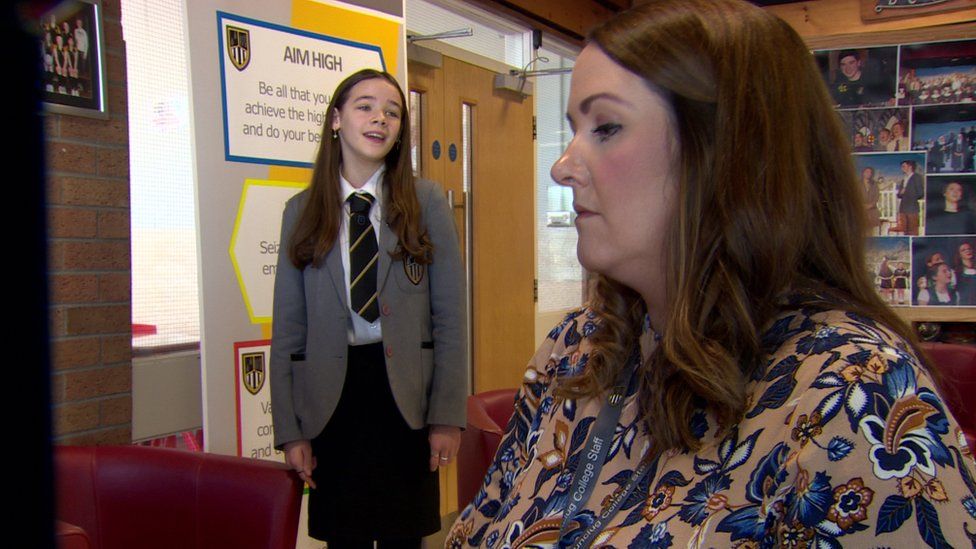 Lacey Aiken sings as a teacher at Dunclug College plays the piano