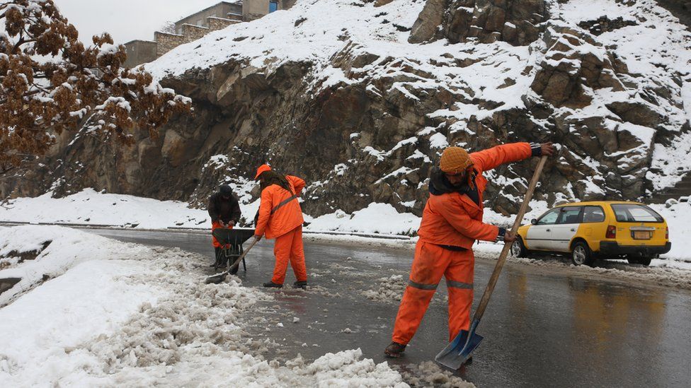 Personnel shovel snow after the heaviest snowfall of the year in Kabul, Afghanistan on January 11, 2023.