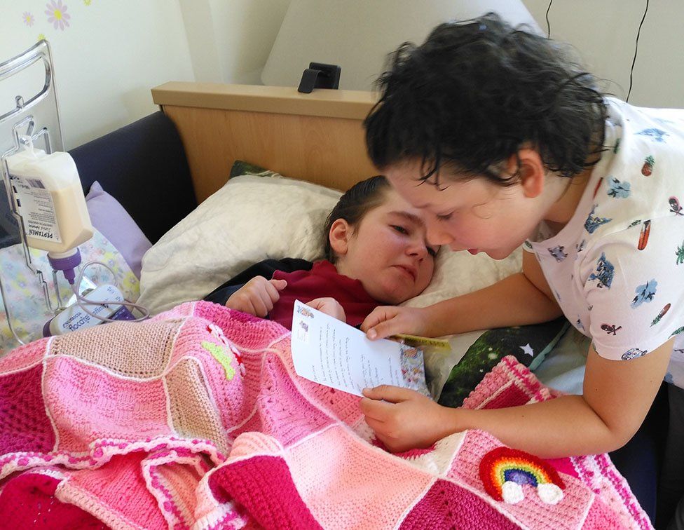 Joe reading to his older sister Connie