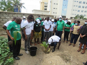 A photograph of Attorney General planting a tree