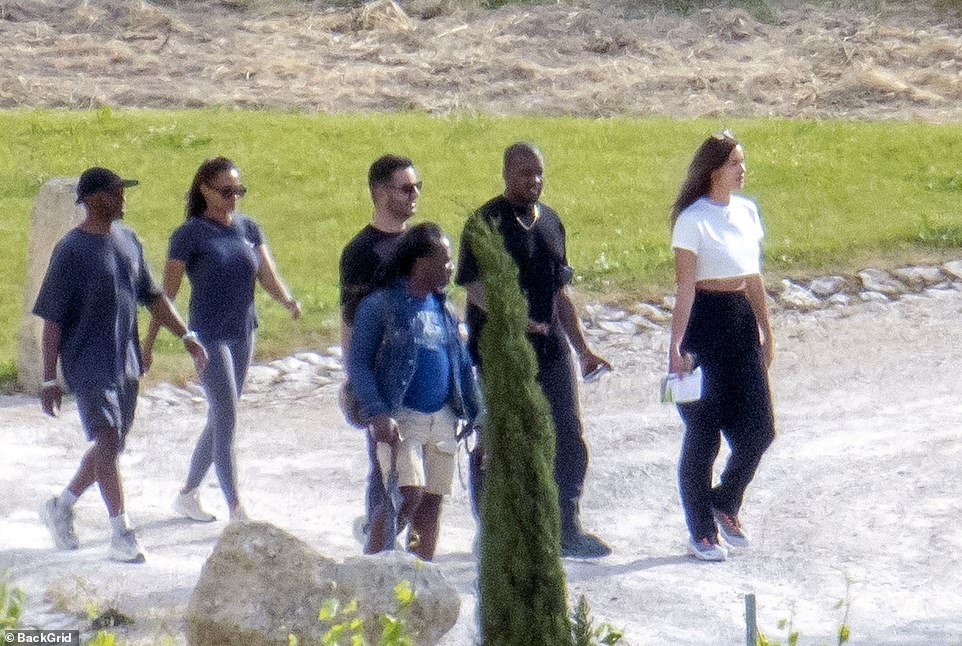 All together: Kanye and Irina were joined by members of his team for the day out on his birthday