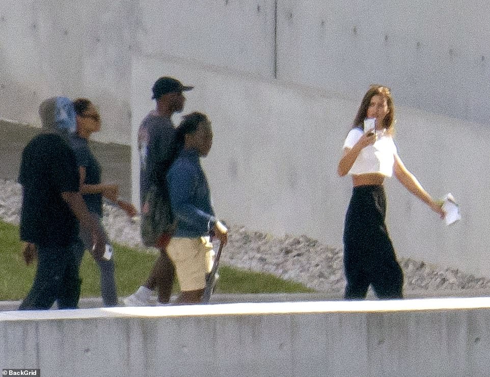 Stunning: Irina showed off her supermodel physique in a crop top, as Kanye and his team followed close behind