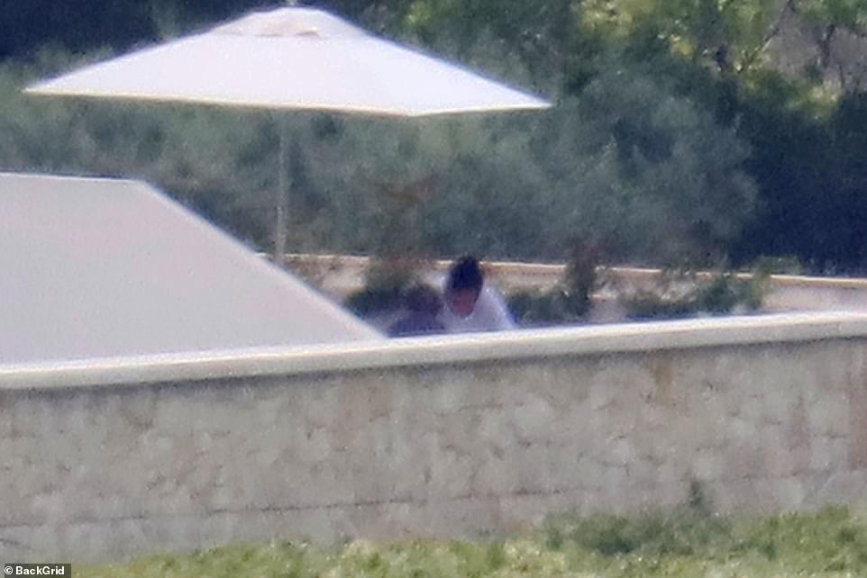 Secluded: The duo could later be seen sitting down together under a parasol as they celebrated his birthday