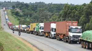 A photo of trucks in a queue