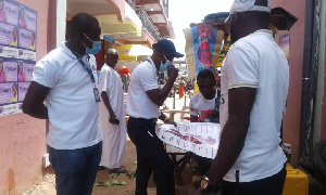 Albert Ankomah, regional FDA Head, interacting with people at the lorry station