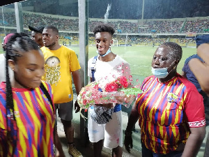 Odoi receiving the gift from the Hearts fans