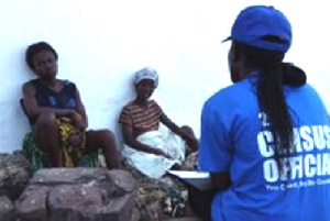 A census enumerator interfacing with some citizens