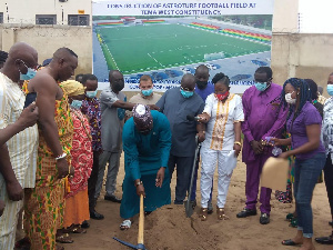 Carlos Kingsley Ahenkorah cutting sod for the construction of an ultra-modern Astroturf