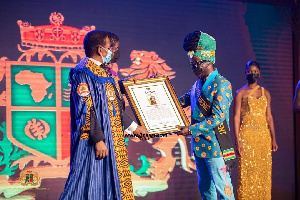 Kojo Antwi receives his citation at the awards event