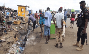 Some Ghanaians desilting choked gutter