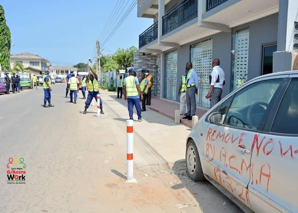 May be an image of one or more people, people standing, car and road