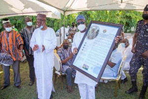 Speaker Alban Bagbin displays a plaque he was presented