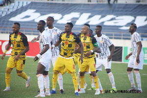 The Black Stars of Ghana in yellow during a football match