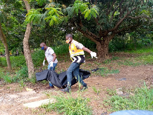 File photo of a corpse being carried in a body bag