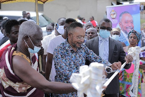 Reverend Owusu Bempah cutting the ribbon to officially commission the project