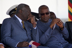 Mahama and Kufuor confering at a public gathering