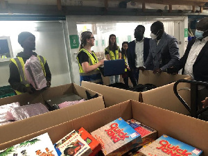 Frank Annoh Dompreh inspecting some of the books